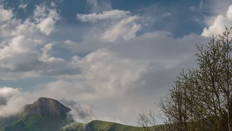 The formation and movement of clouds over the summer slopes of Bolshoy Thach Stock Footage 83493553