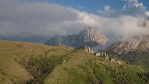 The formation and movement of clouds over the summer slopes of Bolshoy Thach Stock Footage 83493559