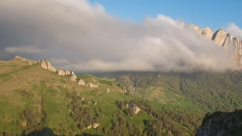The formation and movement of clouds over the summer slopes of Bolshoy Thach Stock Footage 83493560