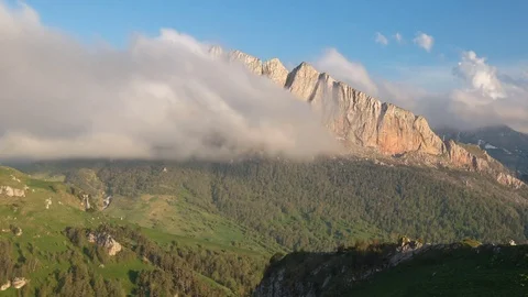The formation and movement of clouds over the summer slopes of Bolshoy Thach Stock Footage 83493563