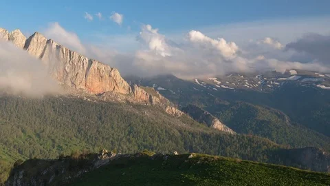 The formation and movement of clouds over the summer slopes of Bolshoy Thach Stock Footage 83493564
