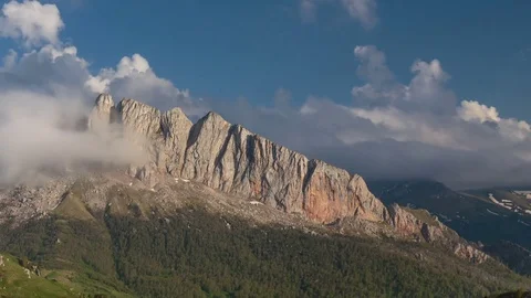 The formation and movement of clouds over the summer slopes of Bolshoy Thach Stock Footage 83493567