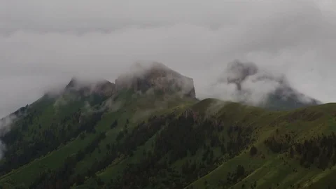 The formation and movement of clouds over the summer slopes of Bolshoy Thach Stock Footage 83517616