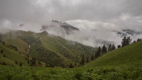 The formation and movement of clouds over the summer slopes of Bolshoy Thach Stock Footage 83518066