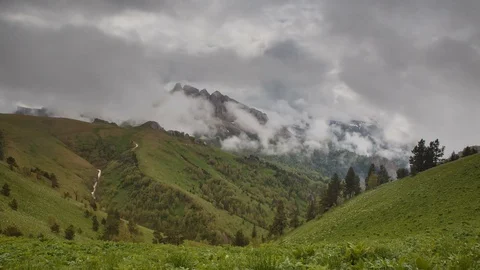 The formation and movement of clouds over the summer slopes of Bolshoy Thach Stock Footage 83518335
