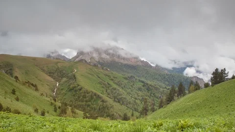 The formation and movement of clouds over the summer slopes of Bolshoy Thach Stock Footage 83518545