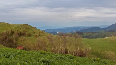The formation and movement of clouds over the summer slopes of Bolshoy Thach Stock Footage 83518618