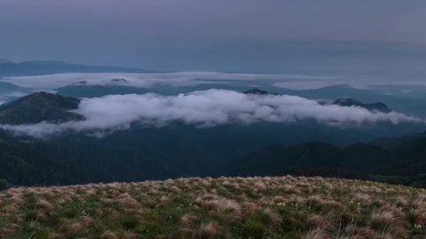 The formation and movement of clouds over the summer slopes of Bolshoy Thach Stock Footage 83518757