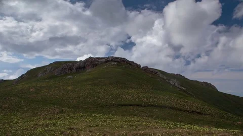 The formation and movement of clouds over the summer slopes of Bolshoy Thach Stock Footage 83518856