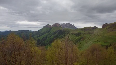 The formation and movement of clouds over the summer slopes of Bolshoy Thach Stock Footage 83519479