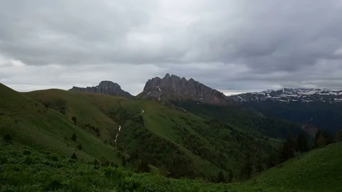 The formation and movement of clouds over the summer slopes of Bolshoy Thach Stock Footage 83591264