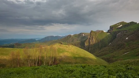 The formation and movement of clouds over the summer slopes of Bolshoy Thach Stock Footage 83593156