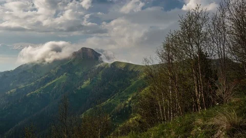 The formation and movement of clouds over the summer slopes of Bolshoy Thach Stock Footage 83595404