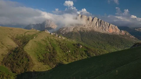 The formation and movement of clouds over the summer slopes of Bolshoy Thach Stock Footage 83596755