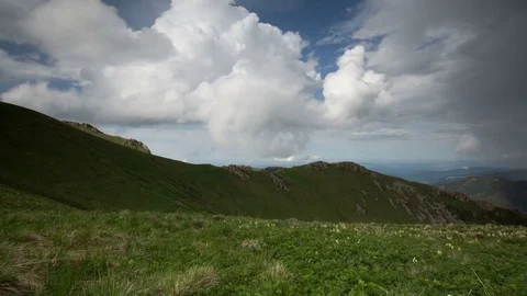 The formation and movement of clouds over the summer slopes of Bolshoy Thach Stock Footage 83597278