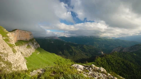 The formation and movement of clouds over the summer slopes of Mountains Stock Footage 149353078