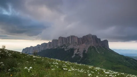 The formation and movement of clouds over the summer slopes of Mountains Stock Footage 149353257