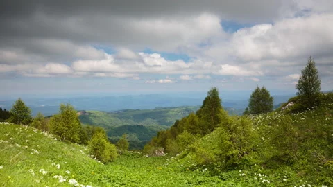 The formation and movement of clouds over the summer slopes of Mountains Stock Footage 149353382