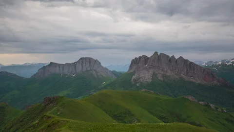 The formation and movement of clouds over the summer slopes of Mountains Stock Footage 149354005