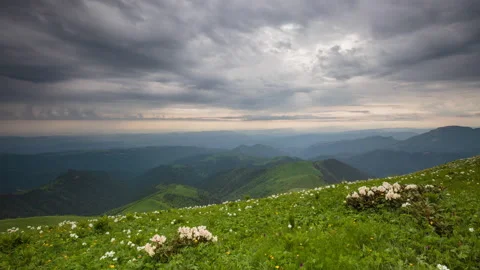 The formation and movement of clouds over the summer slopes of Mountains Stock Footage 149354026