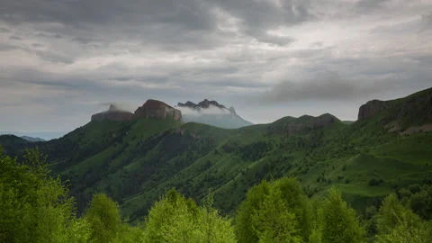 The formation and movement of clouds over the summer slopes of Mountains Stock Footage 149354042