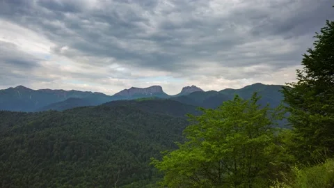 The formation and movement of clouds over the summer slopes of Mountains Stock Footage 149980651