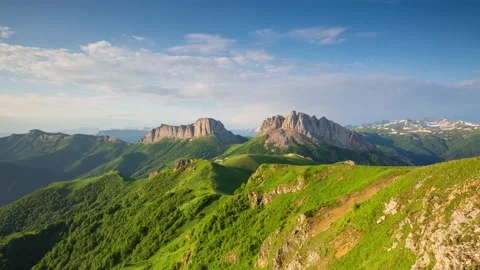 The formation and movement of clouds over the summer slopes of Mountains Stock Footage 149980738