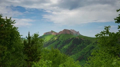 The formation and movement of clouds over the summer slopes of Mountains Stock Footage 149980751