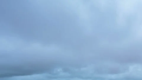 Formation and movement of white clouds of different shapes in the blue sky Stock Footage 94897361