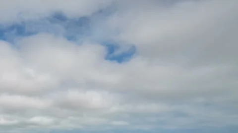 Formation and movement of white clouds of different shapes in the blue sky Stock Footage 94897404