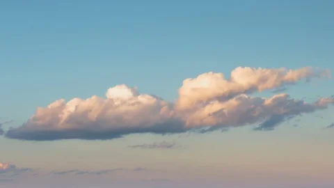Formation and rapid movement of white clouds of different shapes at sunset Stock Footage 75965815