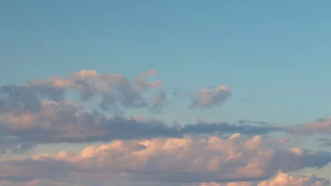 Formation and rapid movement of white clouds of different shapes at sunset Stock Footage 75965837