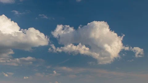 Formation and rapid movement of white clouds of different shapes at sunset Stock Footage 75965847