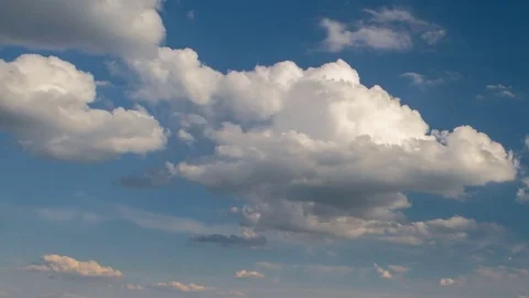Formation and rapid movement of white clouds of different shapes at sunset Stock Footage 75965865