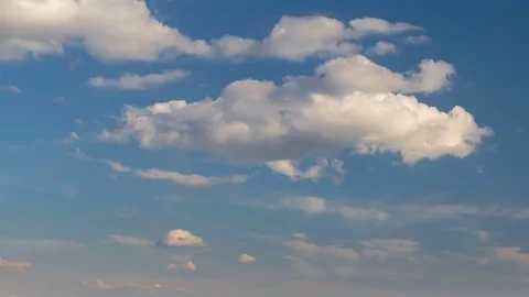 Formation and rapid movement of white clouds of different shapes at sunset Stock Footage 75965878