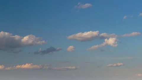 Formation and rapid movement of white clouds of different shapes at sunset Stock Footage 75965894