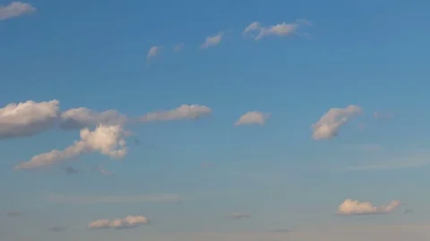 Formation and rapid movement of white clouds of different shapes at sunset Stock Footage 75965903