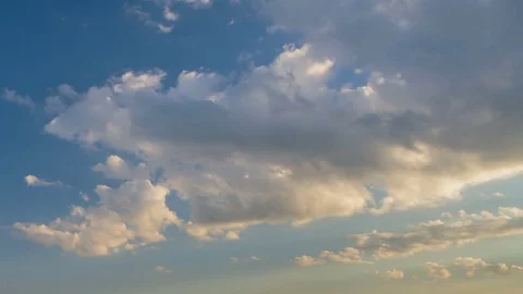 Formation and rapid movement of white clouds of different shapes at sunset Stock Footage 75965909