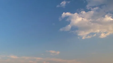 Formation and rapid movement of white clouds of different shapes at sunset Stock Footage 75965921