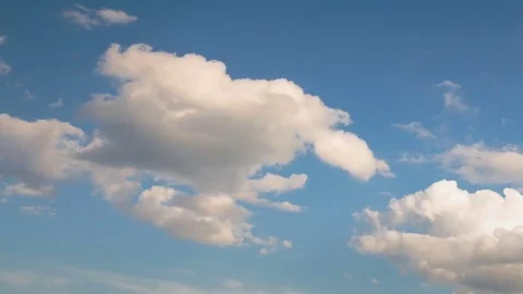 Formation and rapid movement of white clouds of different shapes at sunset Stock Footage 75965947