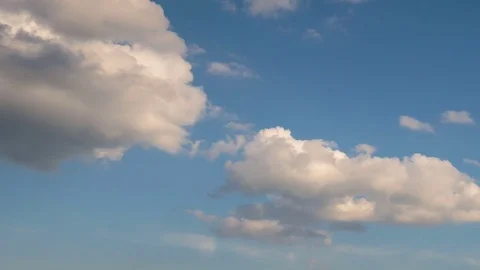 Formation and rapid movement of white clouds of different shapes at sunset Stock Footage 75965959