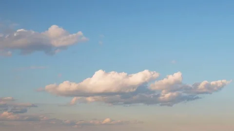 Formation and rapid movement of white clouds of different shapes at sunset Stock Footage 75965968