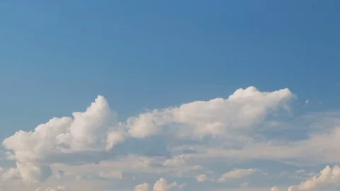 Formation and rapid movement of white clouds of different shapes at sunset Stock Footage 76197592