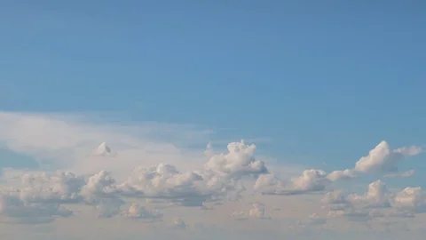 Formation and rapid movement of white clouds of different shapes at sunset Stock Footage 76197824