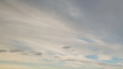 Formation and rapid movement of white clouds of different shapes in the blue sky Stock Footage 77734023