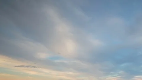 Formation and rapid movement of white clouds of different shapes in the blue sky Stock Footage 77734164