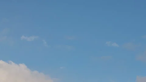 Formation and rapid movement of white clouds in the blue sky in spring Stock Footage 90397937