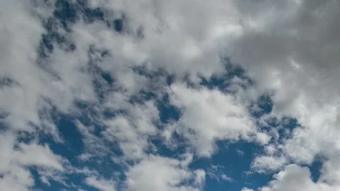 Formation and rapid movement of white clouds in the blue sky in spring Stock Footage 90397985