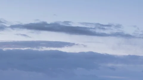 Formation and rapid movement of white clouds of different shapes in the blue sky Stock Footage 103377000