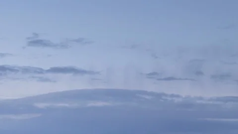 Formation and rapid movement of white clouds of different shapes in the blue sky Stock Footage 103377702